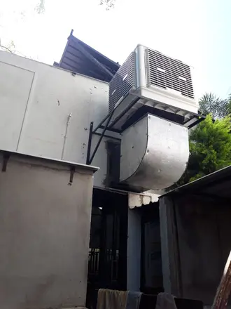 Wall-mounted cooler with duct elbow
